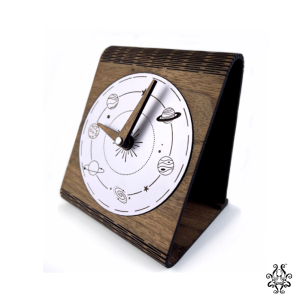 Wooden desk clock with a space-themed design viewed from the side angle.