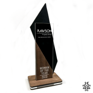 Black & Walnut Trophy with Rawson Property Group Logo and "Woman of the Year 2023" Engraving.