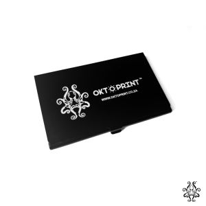 Black metal business card holder with an engraved logo and website URL.