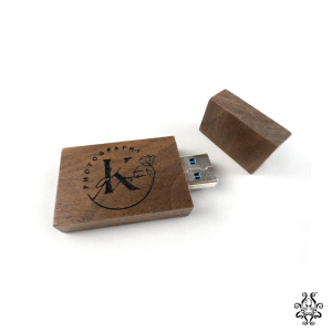 Open engraved wooden USB drive with walnut casing, exposing the USB 3.0 connector.