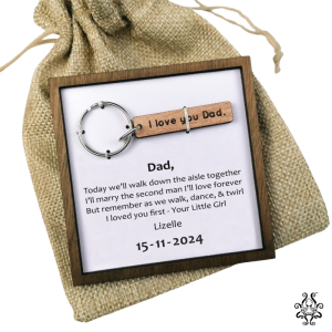Father of the bride gift keychain with personalised message in a wooden frame on a rustic burlap pouch.