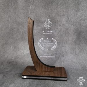 Shield Trophy made from walnut veneer and clear acrylic with customizable engraving for award ceremonies and achievements.